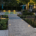 Sfeervolle tuin met keramische tegels, beplanting, spiegelvijver en verlichting